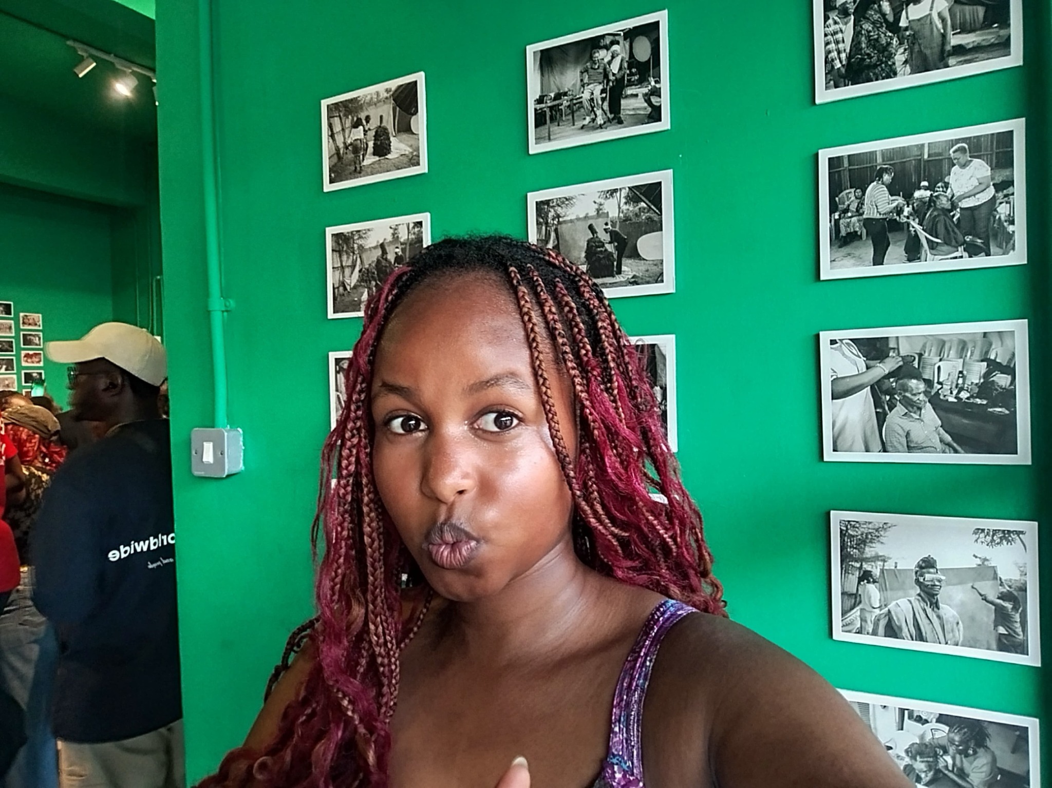 Juanita posing playfully at a photography gallery